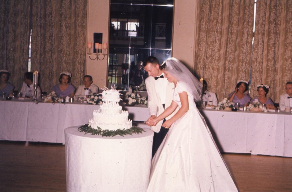 Bride and groom cutting wedding cake